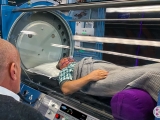 Dr. Milgrom on Phone with Patient in our Hyperbaric Oxygen Therapy Chamber