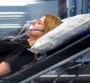 Female patient relaxing in a hyperbaric oxygen chamber