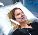 Female patient relaxing in Sechrist hyperbaric chamber.