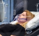 Female patient inside Sechrist hyperbaric chamber