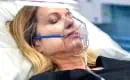 Close-up of Female Wearing Oxygen Mask While Inside a Sechrist Hyperbaric Chamber