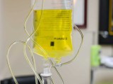 IV bag full of vitamins hanging from an IV pole.