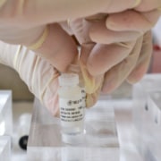 Researcher opening a vial of mesenchymal stem cells.