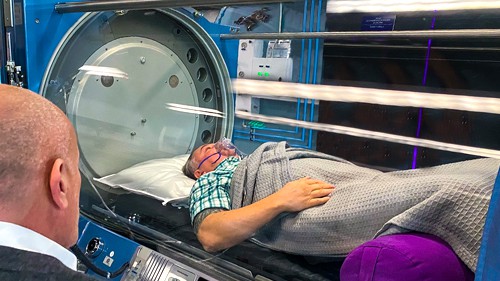 Dr. Milgrom observing a patient in one of our Sechrist H-Series Monoplace Hyperbaric Chambers. 