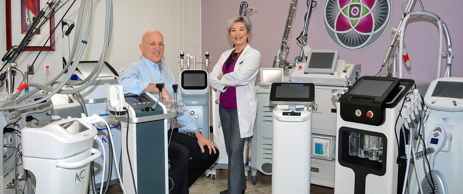 Dr. Asher Milgrom and Dr. Alice Pien with their forest of 30 cosmetic lasers.