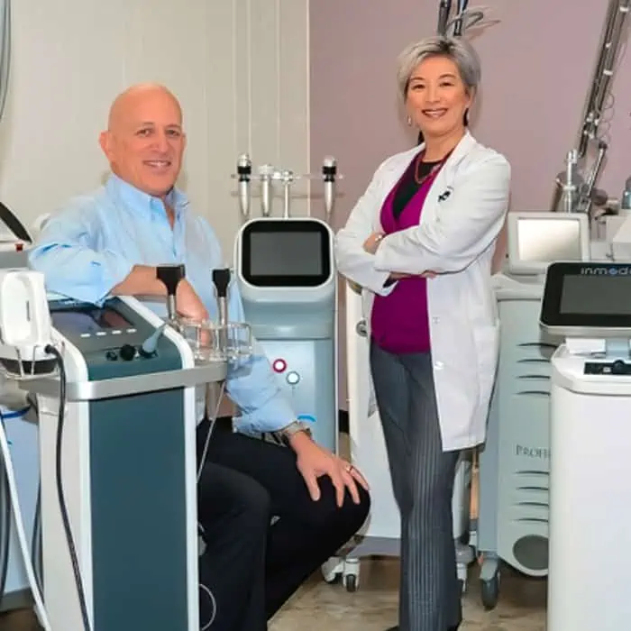 Dr. Asher Milgrom and Dr. Alice Pien with their forest of 30 cosmetic lasers.