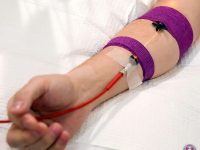 Patient receiving intravenous yellow light photobiomodulation therapy to help treat chronic Long COVID symptoms.