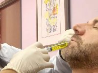 A medical professional delivers a localized ozone injection to treat a patient's chronic sinus problems.