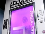 Full body cryotherapy chamber with man inside.