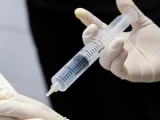 A doctor injects ozone into a patient's joint to stimulate regeneration.