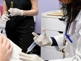 A damaged elbow is injected with ozone to stimulate regeneration.