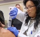 A patient receives an ozone injection into his shoulder.
