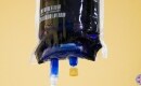 Full IV bag of Methylene Blue hanging from an IV pole ready to treat a Long COVID patient.