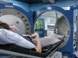 A patient is ready to be slid into the hyperbaric oxygen chamber